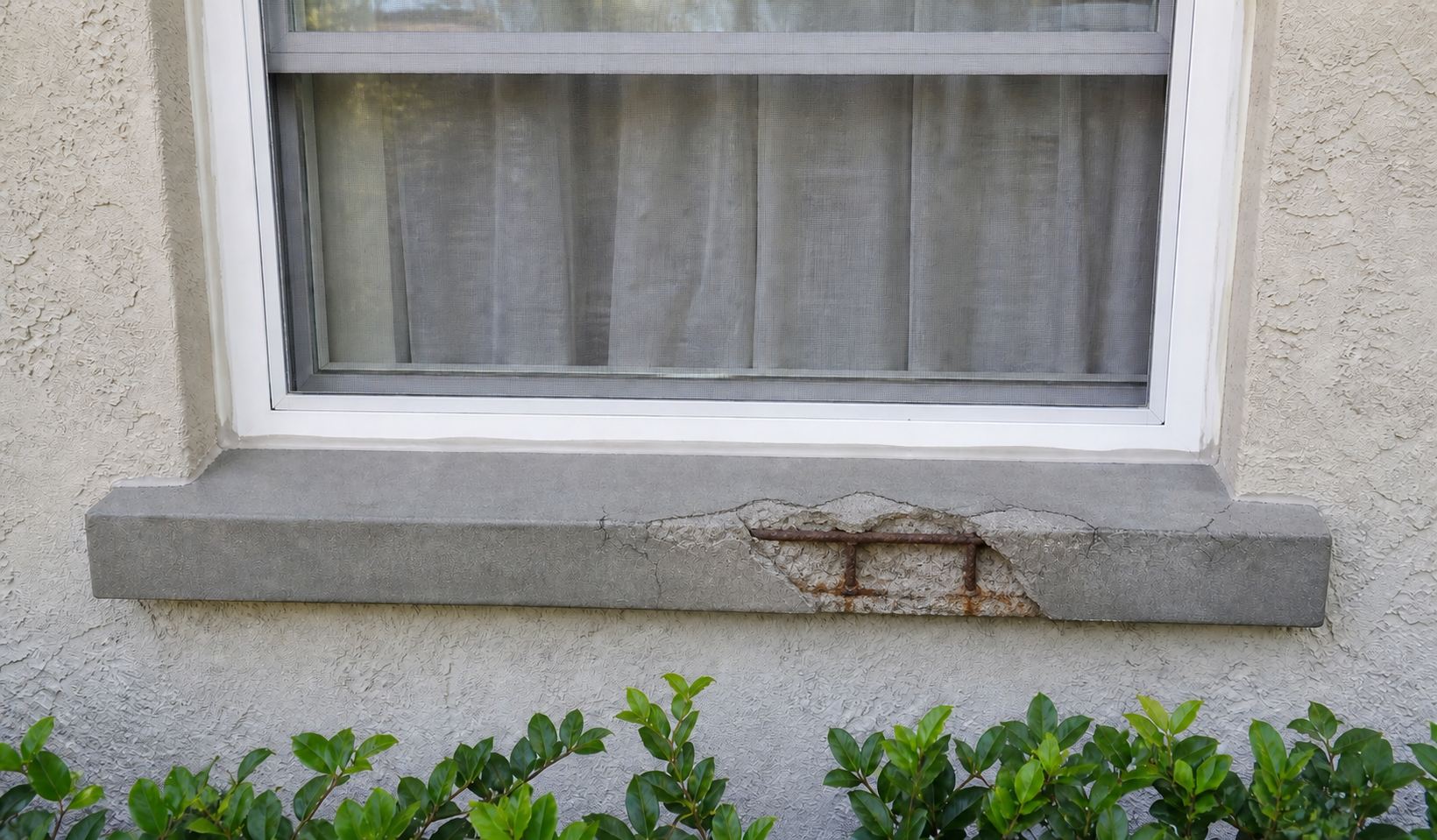 Visualization of a cracked concrete sill with exposed rusted rebar